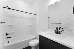 Bathroom featuring vanity and  shower combination
