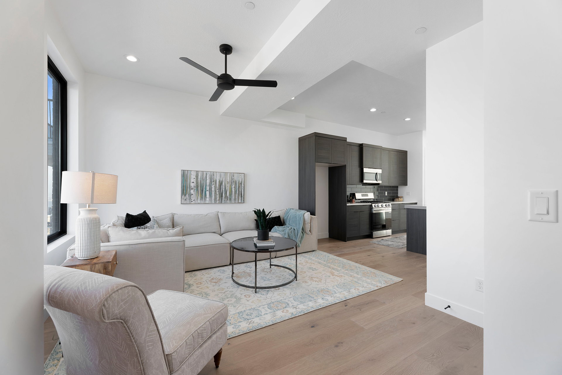 Living room with light wood-type flooring, ceiling fan, and recessed lighting