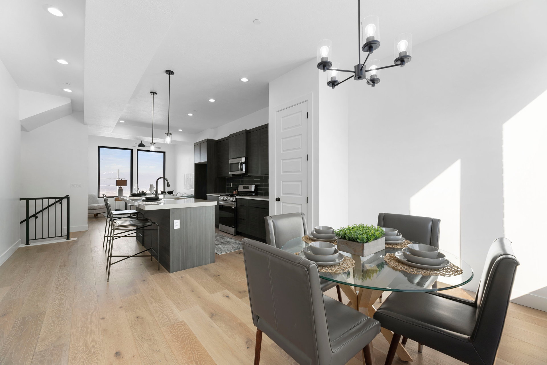 Dining space with light wood finished floors and suspended lighting
