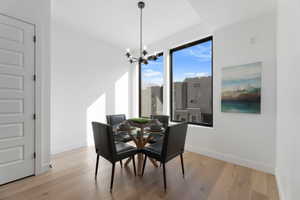 Dining room featuring light wood-style flooring and hanging lights