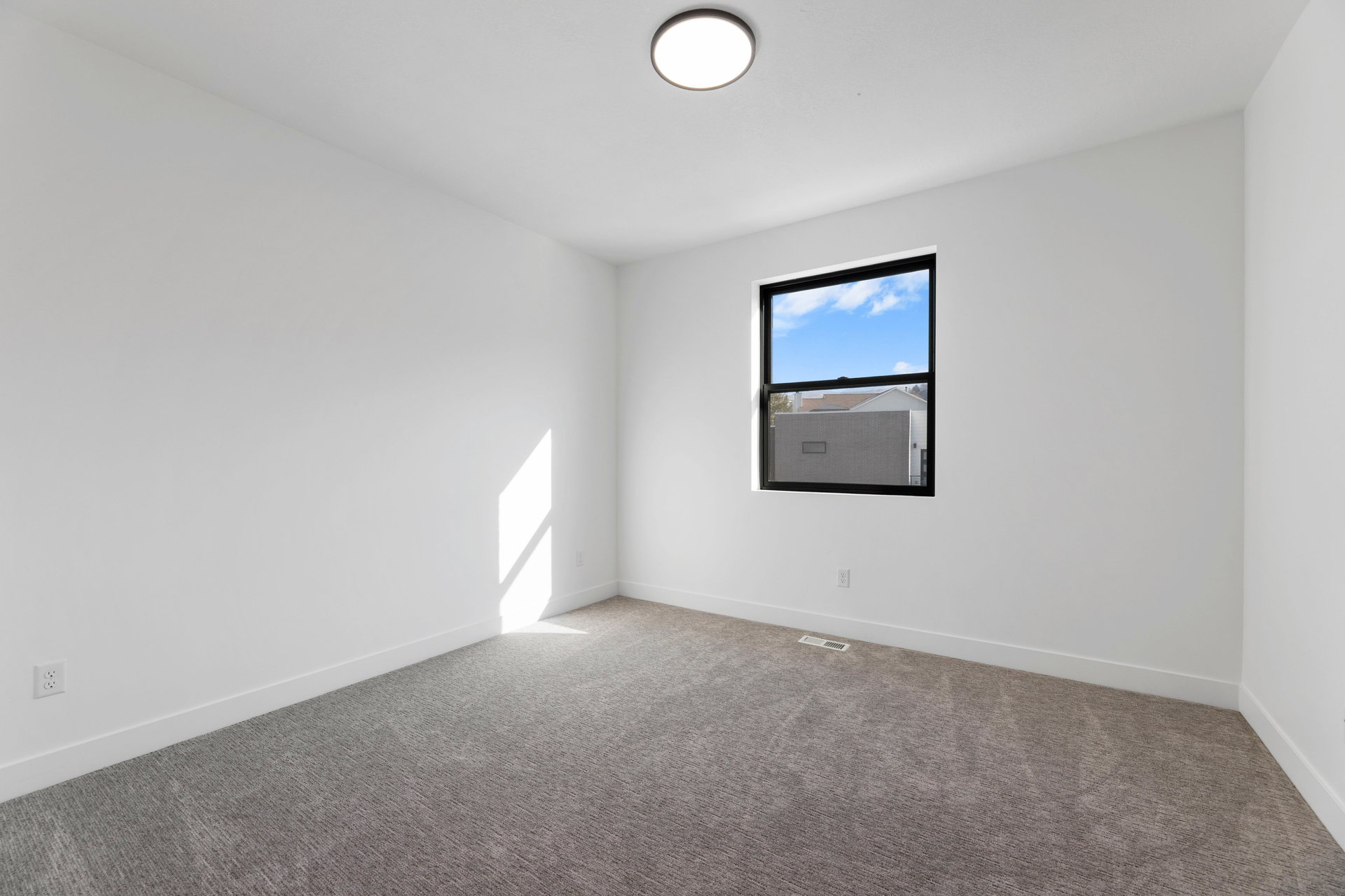 Spare room featuring carpet floors and baseboards