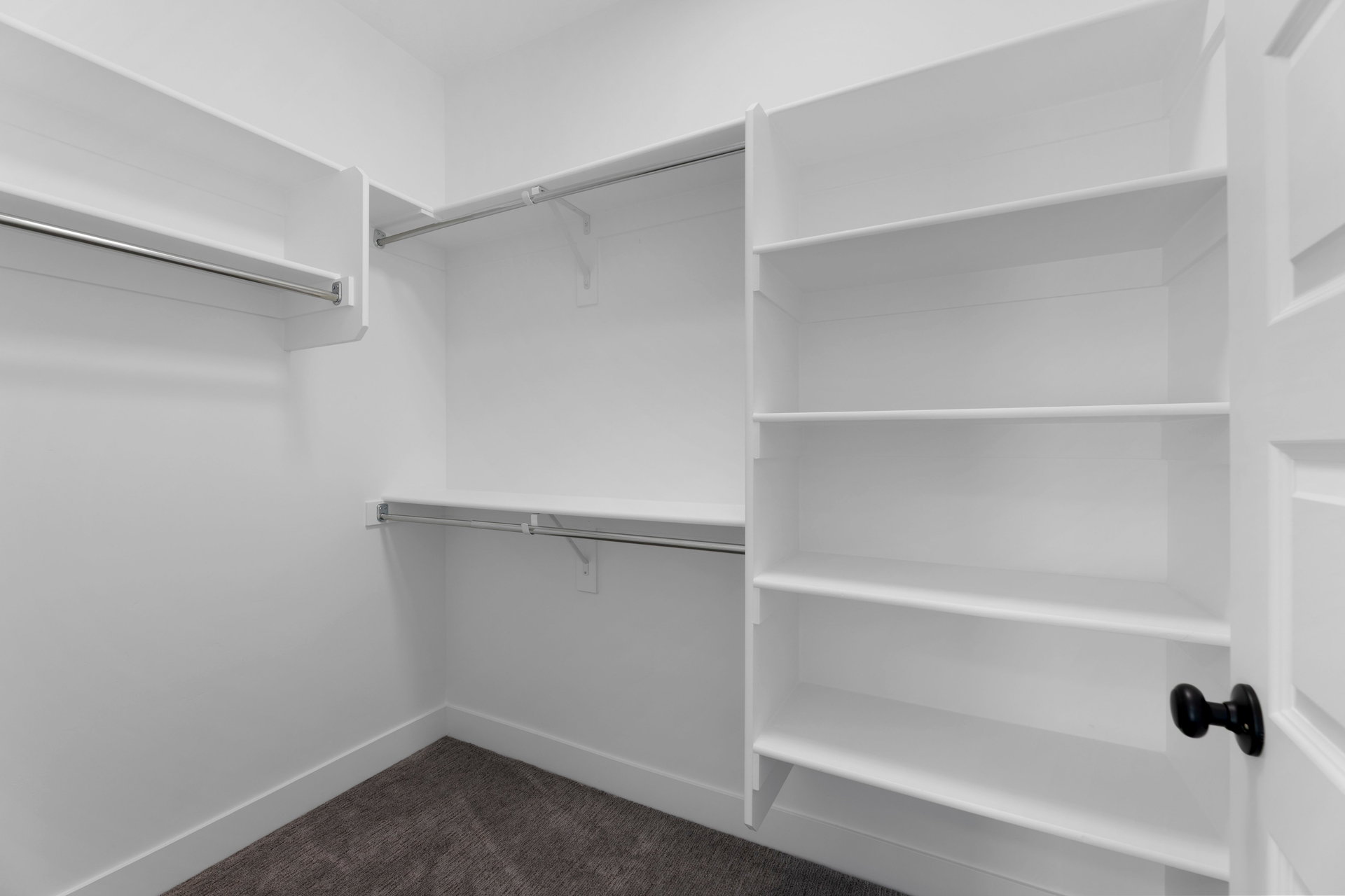 Walk in closet with dark carpet