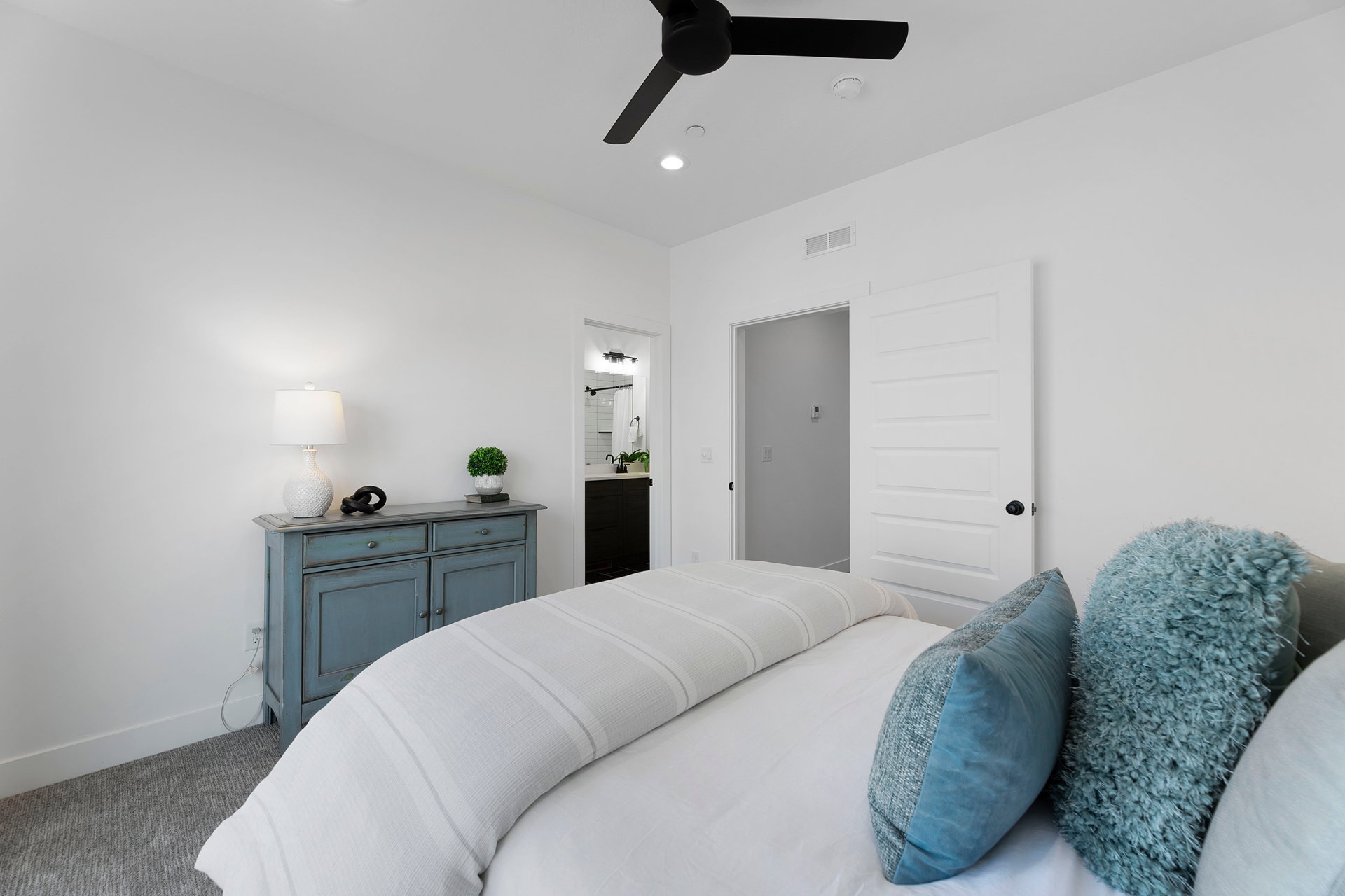 Bedroom with a ceiling fan, carpet flooring, ensuite bath, and recessed lighting