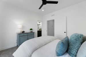 Bedroom with a ceiling fan, carpet flooring, ensuite bath, and recessed lighting