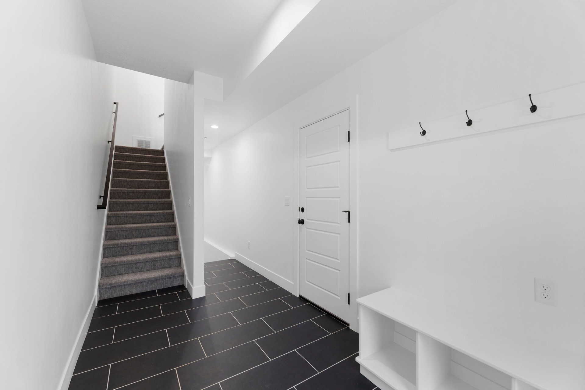 Mudroom with baseboards and dark tile patterned flooring