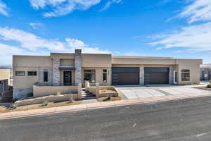 View of front of home featuring stone siding, stucco siding, driveway, and a garage