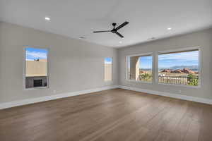 Spare room featuring light wood-style flooring, a mountain view, a ceiling fan, and recessed lighting