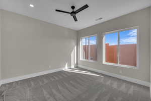 Empty room featuring ceiling fan, carpet, and recessed lighting