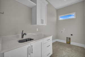 Laundry room featuring washer hookup, cabinet space, and hookup for an electric dryer