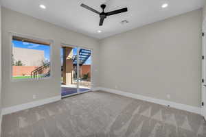 Spare room featuring a ceiling fan, light colored carpet, and recessed lighting