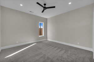 Carpeted spare room featuring ceiling fan and recessed lighting