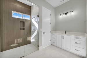 Bathroom featuring vanity and a stall shower