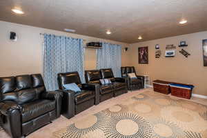 Home theater room with carpet floors, a textured ceiling, and recessed lighting