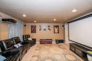 Home theater room with recessed lighting and a textured ceiling