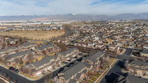 Aerial overview of property's location with nearby suburban area and a mountainous background