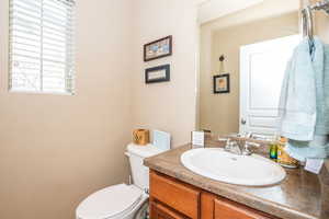 Half bathroom with vanity and toilet