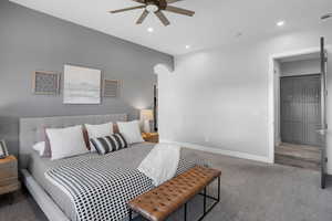 Bedroom featuring carpet, arched walkways, recessed lighting, and a ceiling fan