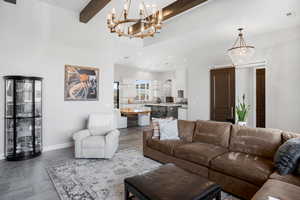 Living area with a chandelier and beamed ceiling