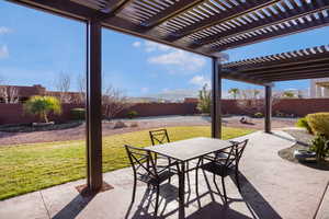 Fenced backyard featuring outdoor dining area, a patio, a mountain view, and a pergola