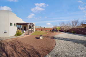 Fenced backyard featuring a patio area and a pergola