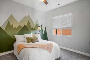 Carpeted bedroom with baseboards and ceiling fan