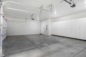 Garage with a garage door opener and electric panel