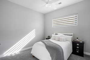 Carpeted bedroom with baseboards and ceiling fan