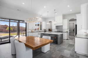 Dining room featuring arched walkways and hanging lights