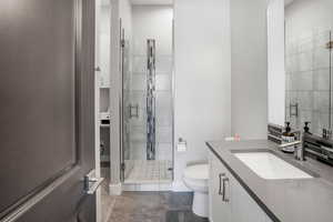 Bathroom featuring a stall shower and vanity