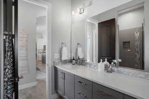 Bathroom featuring vanity and a tile shower