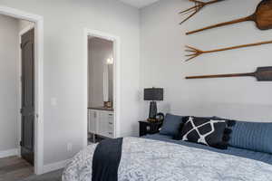 Bedroom featuring ensuite bath and carpet