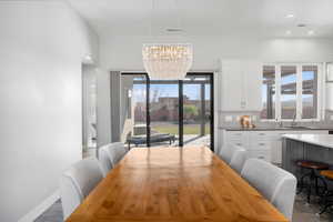 Dining space featuring hanging lights and arched walkways