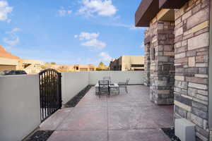View of patio featuring a gate