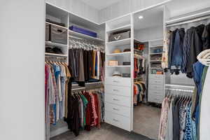 Walk in closet featuring dark carpet