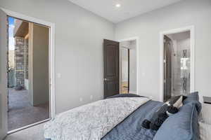 Carpeted bedroom with ensuite bathroom and recessed lighting