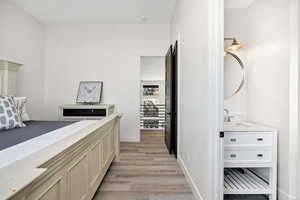 Bedroom with light wood-type flooring and a sink