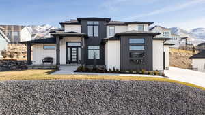 View of front of property featuring a mountain view and roof with shingles
