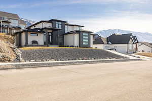 View of front facade featuring a mountain view and concrete driveway