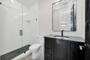 Bathroom featuring vanity, a stall shower, recessed lighting, and light wood-type flooring