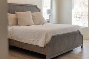 Bedroom with light wood-style floors and baseboards