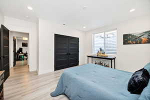 Bedroom featuring light wood-style flooring, a closet, and recessed lighting
