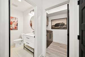 Bathroom with independent washer and dryer and vanity