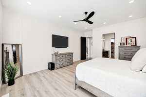 Bedroom with light wood-style floors, recessed lighting, and ceiling fan