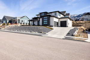 View of front of home featuring driveway and a garage
