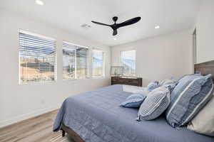Bedroom featuring wood finished floors, a ceiling fan, and recessed lighting