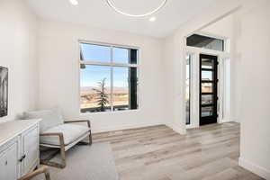 Sitting room featuring light wood-type flooring, recessed lighting, and a mountain view