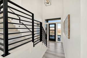 Foyer entrance with a high ceiling and light wood-style flooring