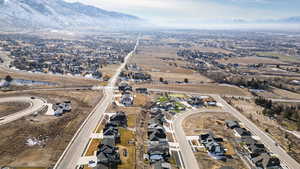 Aerial overview of property's location featuring nearby suburban area and a mountain backdrop