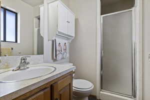Full bath with a shower stall and vanity