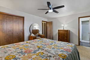 Master Bedroom featuring a closet, a ceiling fan, carpet, and a textured ceiling